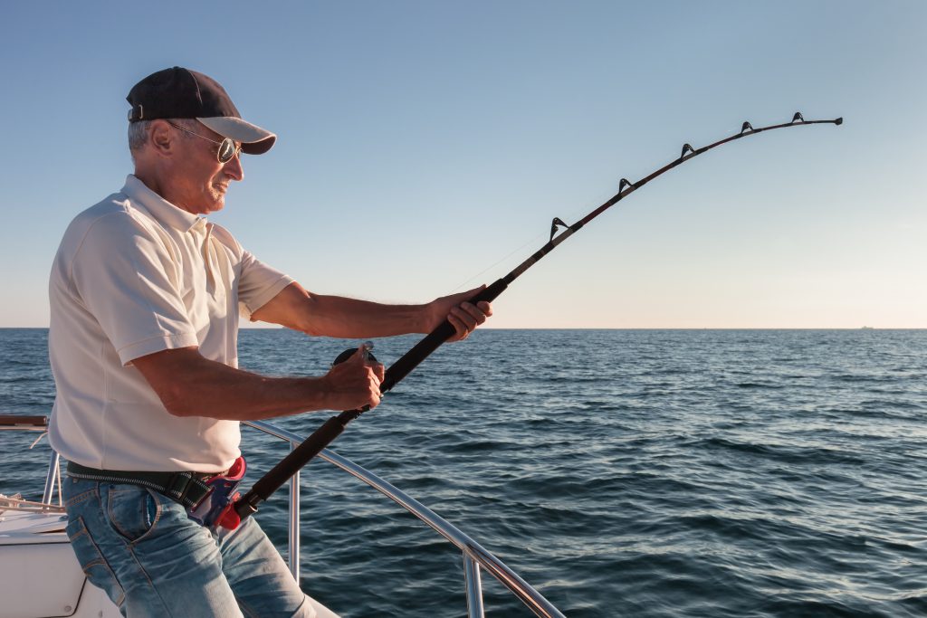 Fishing in the Pacific Ocean on a Boat with Fishing Rods Stock